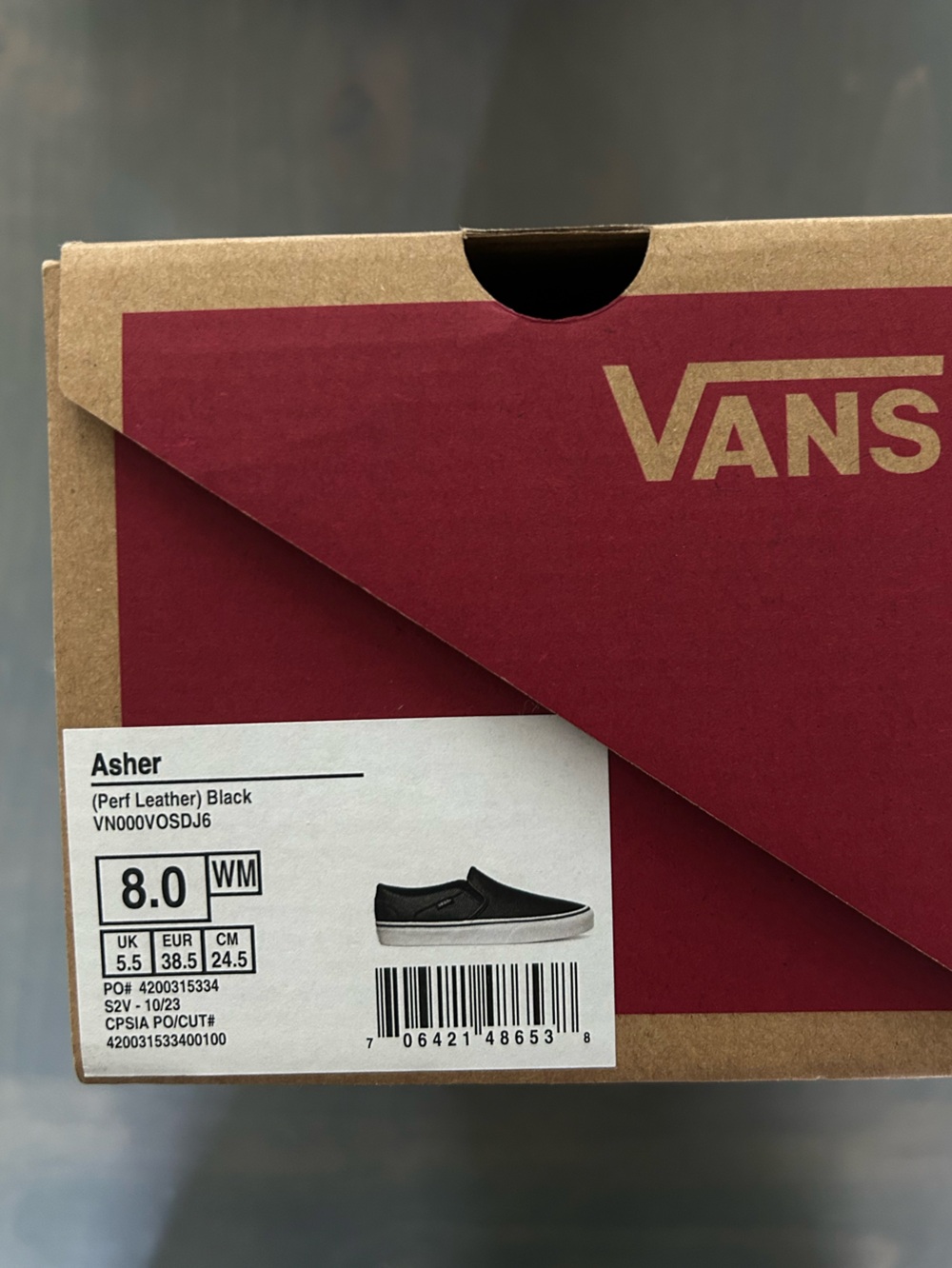 Vans women’s Asher Black Leather Slip-ons